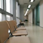 Row of empty chairs in a hospital corridor, soft lighting and modern interior design.